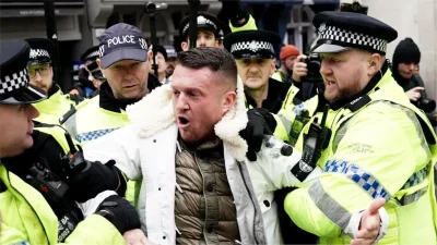 Tommy Robinson charged after attending antisemitism march in London